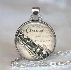 a silver necklace with a musical instrument on it