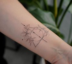 a woman's arm with a flower tattoo on it