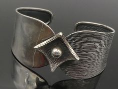 925 Sterling Silver - Vintage Dark Tone Flower Motif Cuff Bracelet - BT5432  925 Sterling Silver - Vintage Dark Tone Flower Motif Cuff Bracelet - BT5432  Jewelry Type:         Bracelet  Metal Type:            925 Silver  Metal Size:             7" Length  1.25" Height   Stone Type:            N/A  Condition:              N/A  Jewelry Weight:     21.2 Grams  PLEASE NOTE: THIS ITEM IS PRE-OWNED. ALTHOUGH MOST ITEMS ARE IN VERY GOOD CONDITION, SOME MAY NEED CLEANING AND/OR MINOR REPAIRS. WE MAKE A Contemporary Silver Cuff Bracelets, Contemporary Silver Cuff Jewelry, Silver Artistic Bracelets For Formal Occasions, Artistic Silver Bracelets For Formal Occasions, Rivet Jewelry, Art Deco Bracelet, Bracelet Metal, Luxe Jewelry, Jewelry Design Ideas