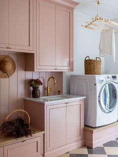 a washer and dryer in a pink laundry room