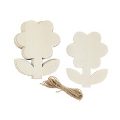 two wooden cutouts with flowers on them and a string attached to the back of each piece