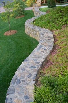 a stone path in the middle of a grassy area