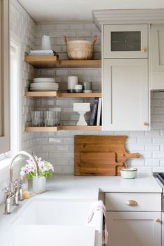 the kitchen is clean and ready for us to use it's white countertops