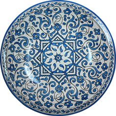 a blue and white plate with an intricate design