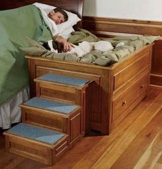 a man sleeping on top of a bed next to a set of stairs in a bedroom