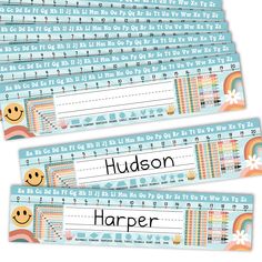 three blue and white name tags with smiley faces on them, one is for hudson