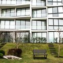 an apartment building with stairs leading up to it