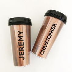 two stainless steel coffee mugs with black lids and the words jersey y on them