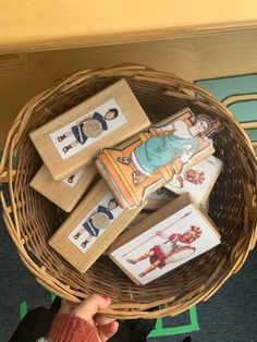 a basket filled with wooden magnets sitting on top of a floor next to a table