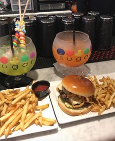 there is a burger and french fries on the plate next to each other at this restaurant