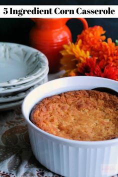 a close up of a casserole dish on a table with flowers in the background