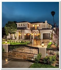 a large house lit up at night with lights on the front and side of it