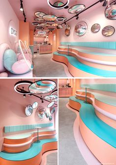 the inside of a pink and blue store with circular mirrors on the wall, curved counter tops, and round ceiling lights