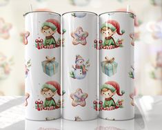 three white coffee mugs decorated with christmas images