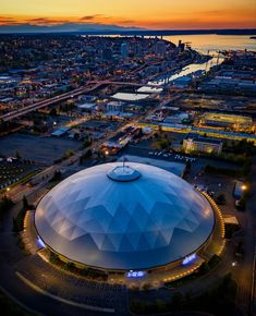 an aerial view of a large blue dome in the middle of a city at night