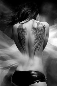 the back of a woman's body with angel wings on it