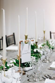 the table is set with candles and place cards