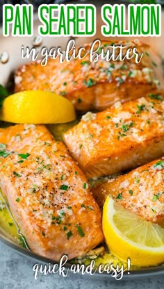 garlic butter salmon in a pan with lemons and herbs