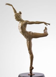 a bronze statue of a woman doing a yoga pose on a black base with her arms stretched out