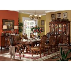 a formal dining room table with chairs and china cabinet