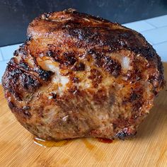 a piece of meat sitting on top of a wooden cutting board