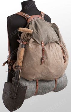 an old backpack is sitting on top of a mannequin