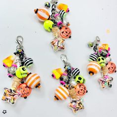 three halloween themed charms on a white surface with black and orange stripes, pumpkins, jack - o'- lanterns, and more