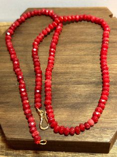 This is a beautiful, vintage, genuine, natural red jade, 14K yellow gold overlay and sterling silver necklace that is 18 inches. The necklace features faceted, natural red jade stones all around it. The jade is so pretty and almost sparkles when the light hits it because of the faceted cut on each piece of jade. The jade measures about 3/16" each in diameter. Jade is believed to bring good luck. The necklace is 3/16" in width and weighs about 12.4 grams. It has a hook style clasp that is hallmar