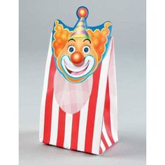 a clown's face is on top of a striped bag with a clown hat