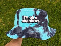 "A hand dyed bucket hat with \"I'm on a sidequest\" embroidered on it. Made by me! Hat size is 22 inches in circumference. All sales final! DM for any questions or custom requests :) im on a sidequest hat brb im on a sidequest rave outfit festival outfit music festival hat bucket hat tie dye rave gift Rave accessories Rave gift Excision Merch Tie dye bucket hat festival gift festival accessories Rave apparel Rave hat Festival merch Excision Merch Tie dye bucket hat bucket hats rave hats festival Rave Outfits Accessories, Camping Music Festival Outfit, Rave Accessories Ideas, Excision Rave Outfit, Music Festival Outfits Rave, Bucket Hat Tie Dye, Rave Hat, Rave Outfits Diy, Edm Concert Outfit