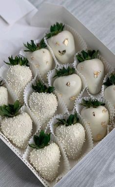 a box filled with white chocolate covered strawberries