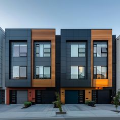 These modern townhouses feature sleek dark façades accented by warm wood panels. Expansive geometric windows ensure bright interiors, while private ground-floor garages and small landscaped front areas add practicality and charm. The clean lines and high-quality materials create a sophisticated urban living environment. Perfect for city dwellers seeking stylish, minimalist homes that blend elegance and functionality. Modern Terrace House Exterior, Apartment Exterior Color Schemes, Modern Townhouse Facade, Single Home Design, Townhouses Architecture, Townhouse Designs Interior, Modern Townhouse Designs, Modern Townhouse Exterior, Modern Townhouse Interior