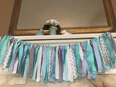 there is a mantle decorated with blue and white streamers