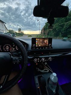 the interior of a car with dashboard, steering wheel and dash board showing various gauges