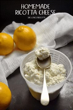 a bowl of ricotta cheese with two oranges in the background and a spoon