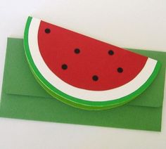 a piece of green paper with a watermelon cut out on the front and bottom