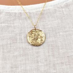 Athena Necklace in 14Kt Gold Filled and Bronze - Gold Owl Pendant - Greek Coin Replica Necklace - Warrior Goddess Necklace - Meaningful & Inspirational Necklaces for Women & Girls This necklace features a replica of an ancient Greek coin with the owl symbol of Athena - warrior goddess, and goddess of wisdom. The Greek letters "AOE" that appear on the side of the coin are an abbreviation for "Of the Athenians." The pendant measures approximately 19mm across (about 3/4 inch), and is made from shining, durable bronze. All chain materials are 14Kt gold-filled. Wear this piece often to remind yourself of your innate inner strength and wisdom. The necklace length is customizable. Choose your perfect length from the drop down menu. The pictured necklace is a 25 inch on a small model. A sterling s Athena Necklace, Athena Symbol, Owl Symbol, Greek Mythology Jewelry, Mythology Jewelry, Gold Owl, Warrior Goddess, Goddess Pendant, Ancient Greek Coin