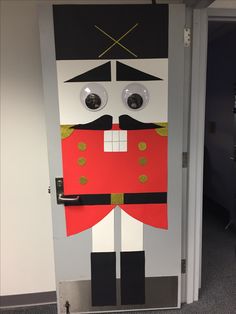 a door decorated to look like a nutcracker with big eyes, nose and mouth