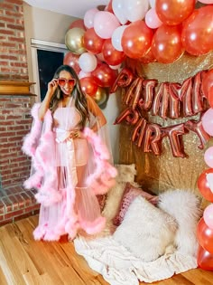 a woman standing in front of some balloons