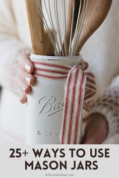 a woman holding a mason jar with whisk in it and the words 25 ways to use mason jars