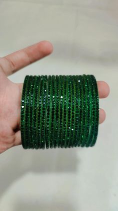 Bangles Name - Penali Burj Khalifa   Color - dark green   Size - 2.2/2.4/2.6/2.8   Weight - 60 grams   Piece - 12   Stone Color- green  100% Glass Bangles & Handmade Product. You can wear it while going to a wedding by matching it with your clothes. You can also gift it to someone. You can also wear it in an engagement. It looks very beautiful in your hands. about shipping  Ships within 1 to 3 business days after payment is received  We ship orders every day except Sundays and holidays  When you Bangles Glass Beautiful, Adjustable Green Emerald Bracelet, Green Round Bracelets For Party, Adjustable Green Bangle For Party, Green Emerald Bracelets For Party, Adjustable Green Round Bangle, Adjustable Green Bangle, Green Bangles, Glass Bracelets