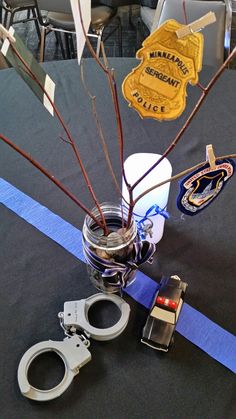 a police themed centerpiece with flowers and handcuffs