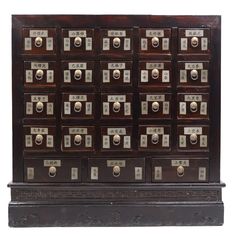 an old wooden cabinet with many drawers and knobs on the front, side view