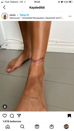 a person's leg with an ankle tattoo on the top and bottom of it