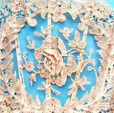 an intricately decorated blue cloth with gold trimmings and flowers on the edges