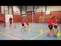 children are playing with cones in an indoor gym