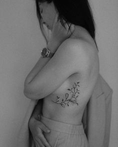 black and white photograph of woman with flower tattoo