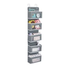 a tall shelf with several bins on it and various items in the bottom section