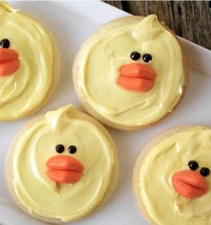 four frosted cupcakes with yellow icing and a rubber ducky face