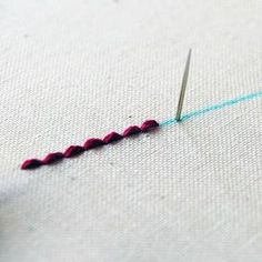 the needle is being used to sew on fabric